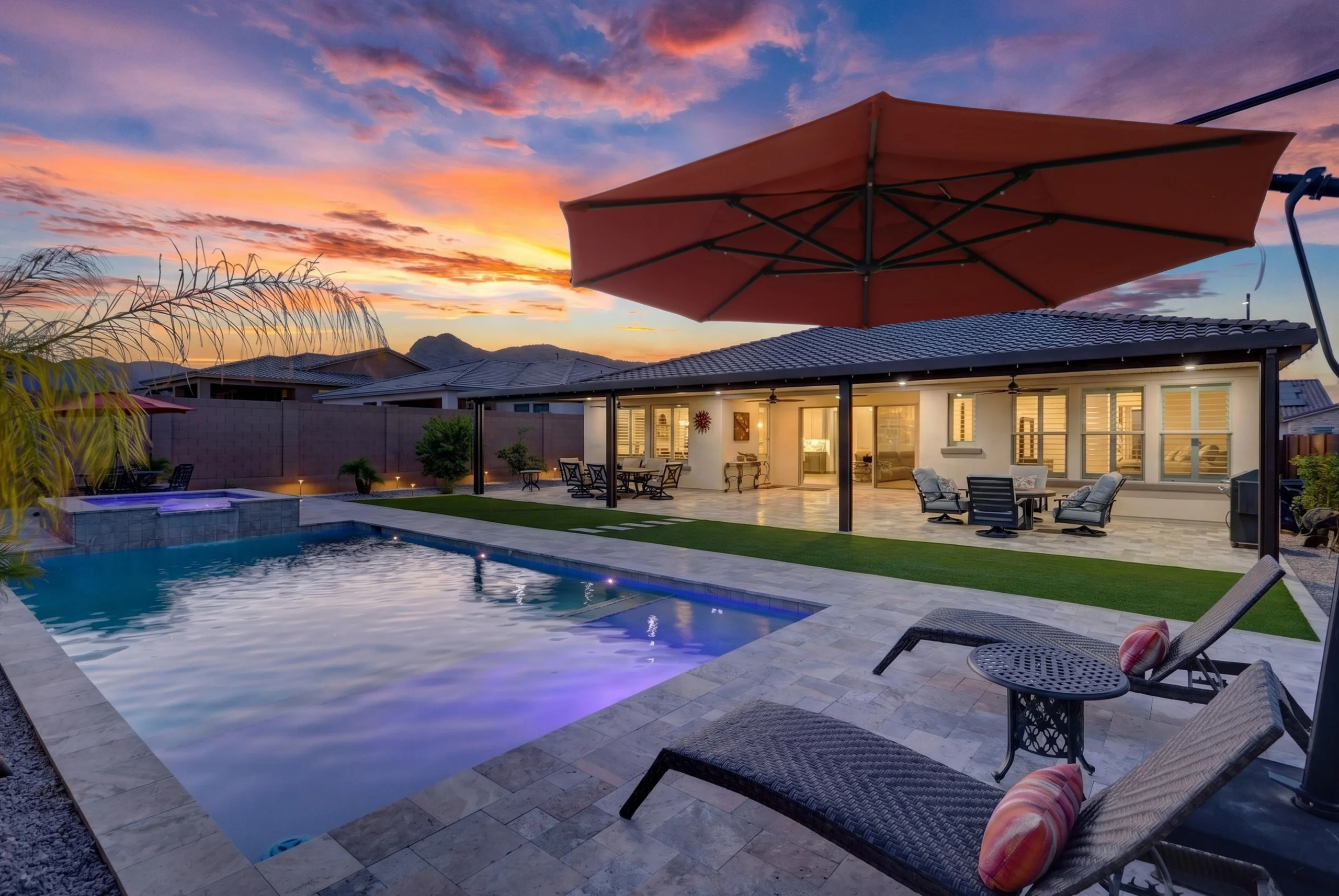 Twilight homes backyard showing a pool